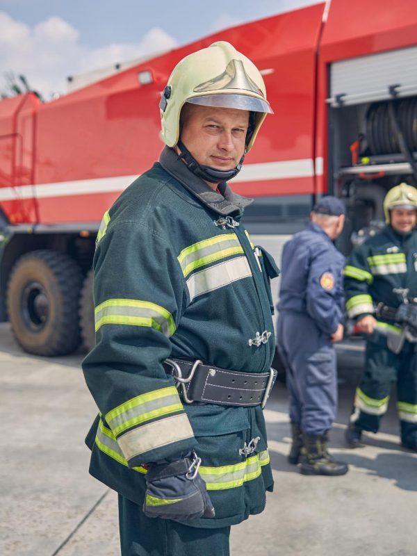 team-of-happy-firefighters-learning-on-trucks-at-f-2023-11-27-05-28-15-utc